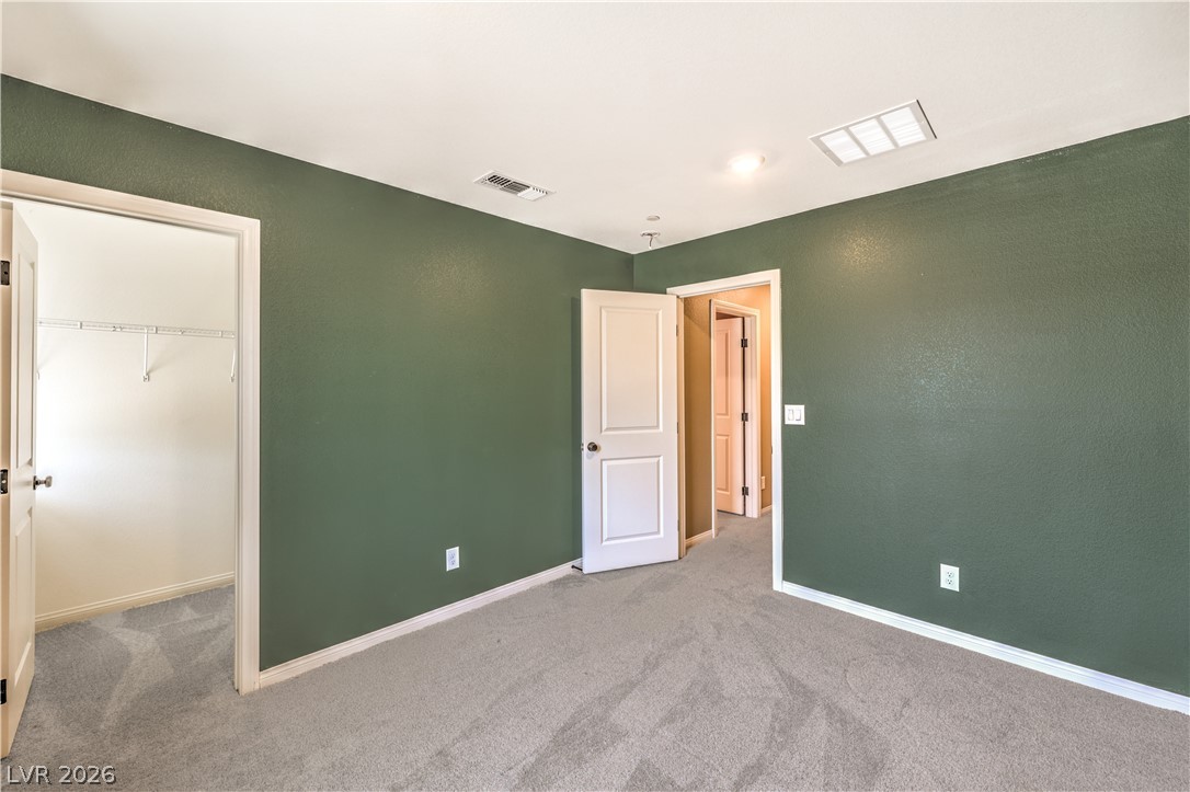 3782 Alla Rocca Avenue Henderson, NV 89044 - Photo 35 of 55 This inviting bedroom features soft carpeting, ready for personalized touches and comfortable living.