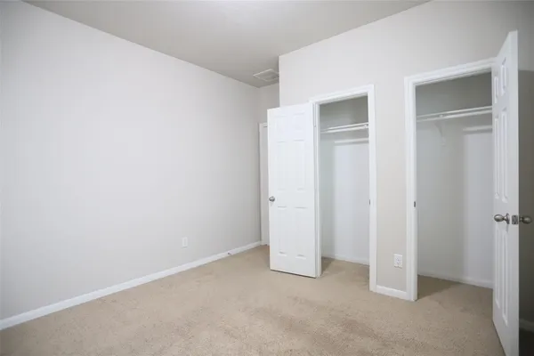 an empty room with closet area