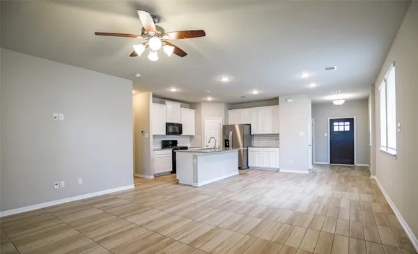 a view of kitchen with sink microwave and refrigerator