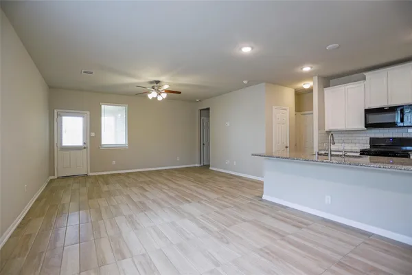a view of a kitchen with microwave and stove