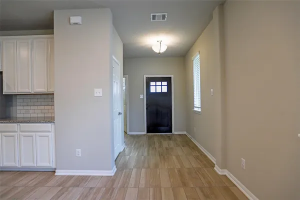 a view of hallway with wooden floor