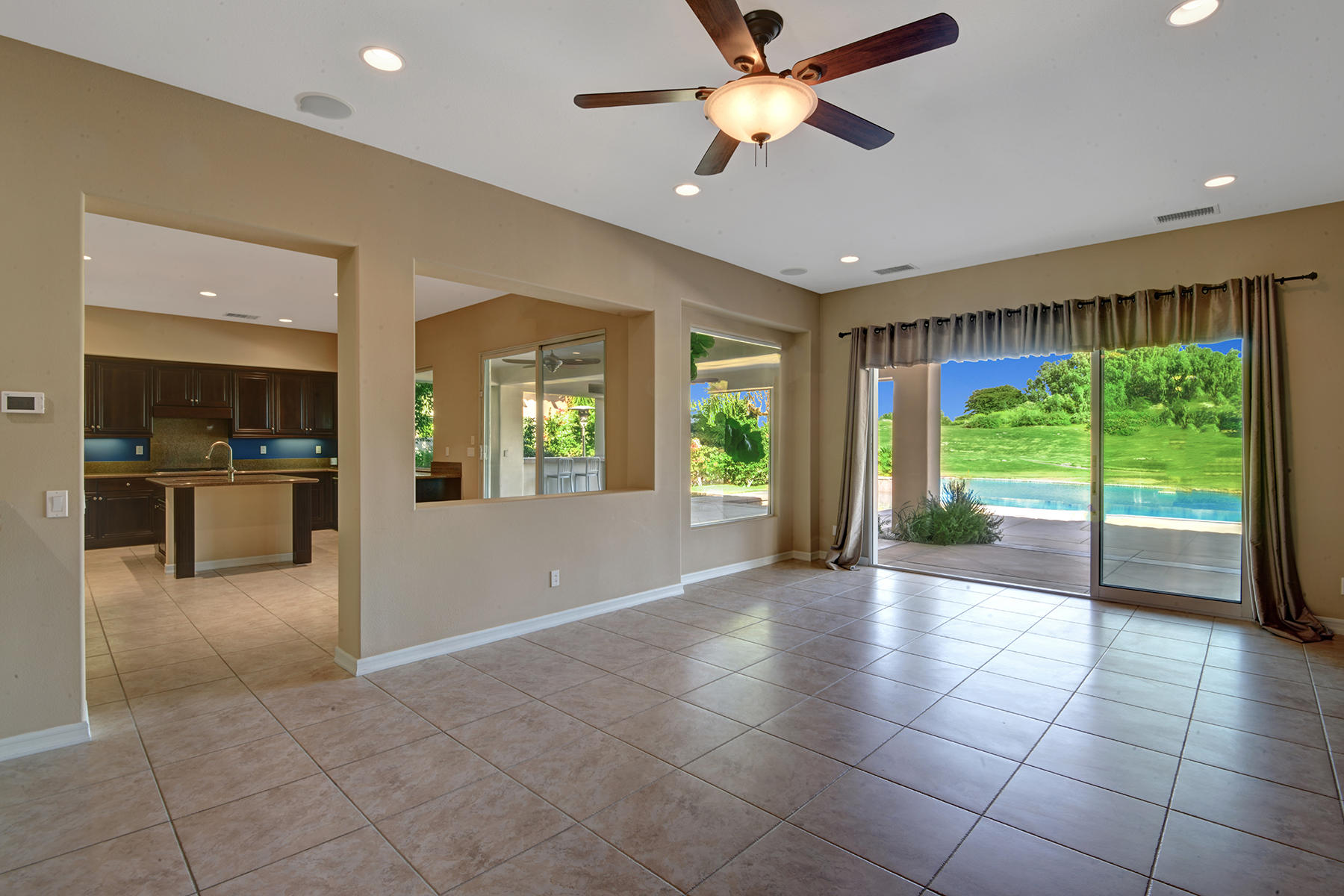 342 Loch Lomond Road Rancho Mirage, CA 92270 - Photo 12 of 35 LIVING ROOM TO POOL AND KITCHEN MLS