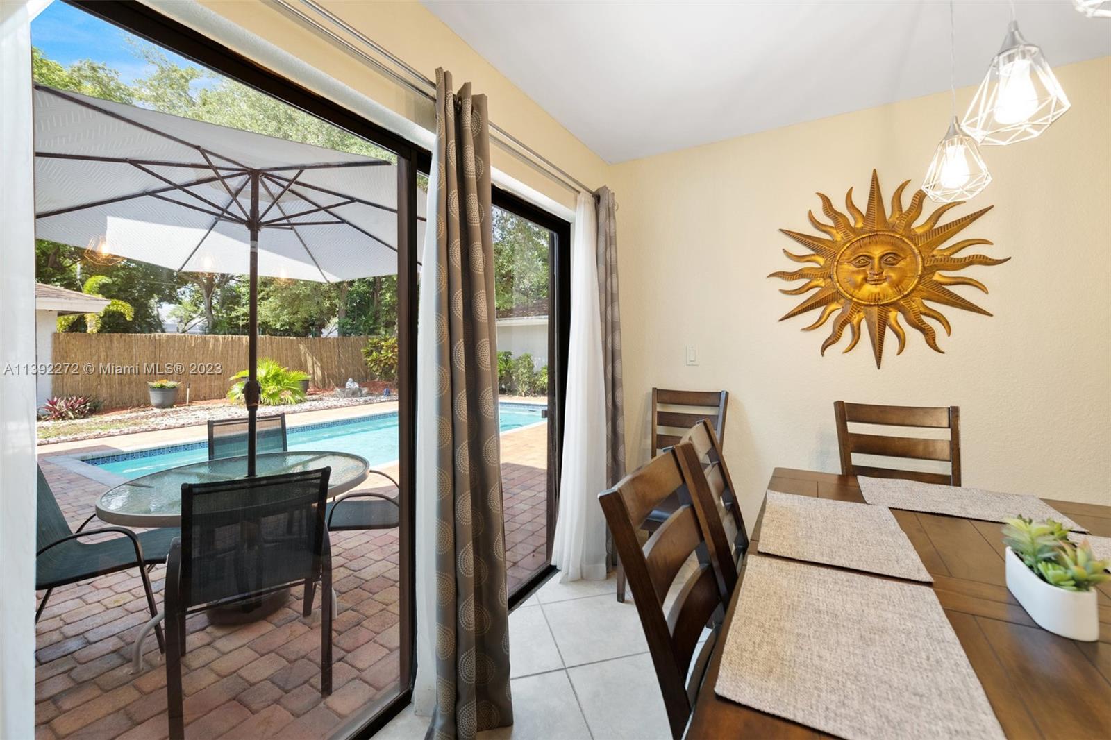 28 Cedar Road Hollywood, FL 33021 - Photo 14 of 43 a view of a dining room with a table and chairs