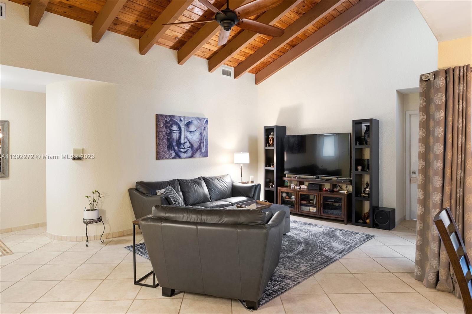 28 Cedar Road Hollywood, FL 33021 - Photo 21 of 43 a living room with furniture and a flat screen tv