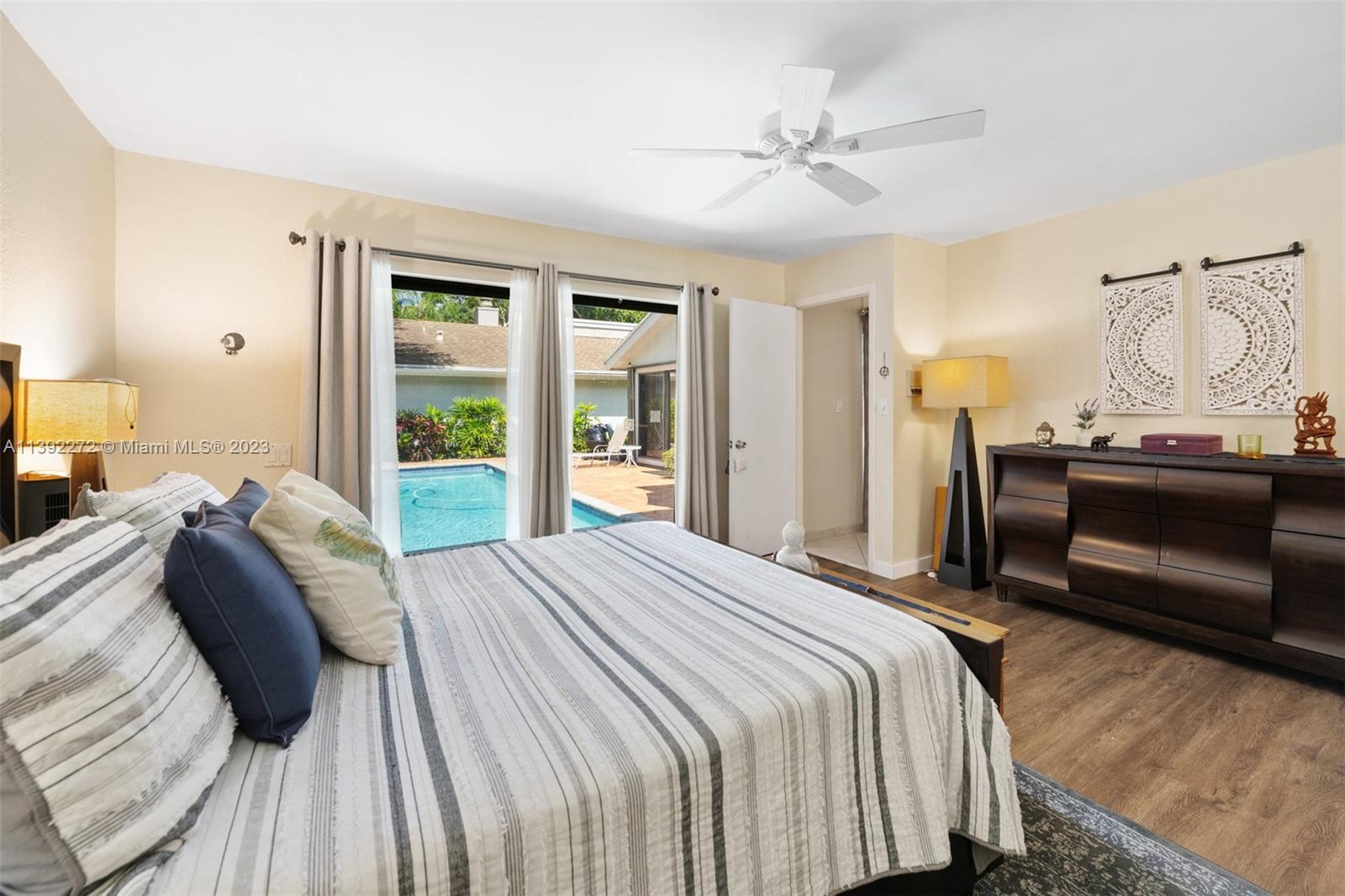 28 Cedar Road Hollywood, FL 33021 - Photo 25 of 43 a bedroom with a bed and a chandelier