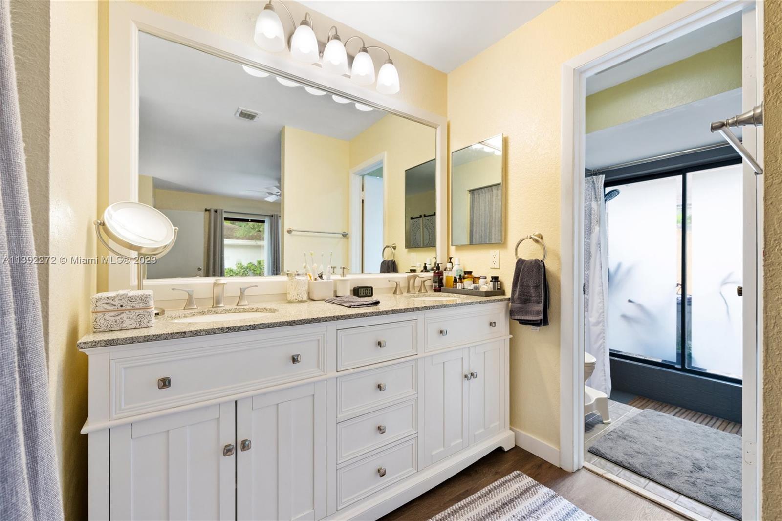 28 Cedar Road Hollywood, FL 33021 - Photo 26 of 43 a bathroom with a granite countertop sink and a mirror
