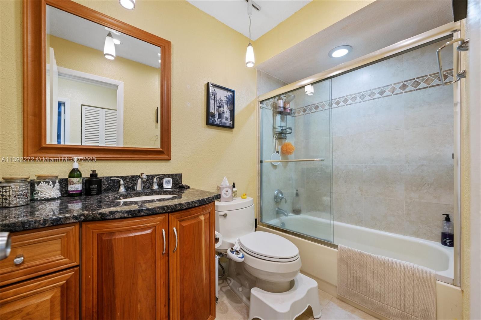 28 Cedar Road Hollywood, FL 33021 - Photo 32 of 43 a bathroom with a granite countertop sink toilet and shower