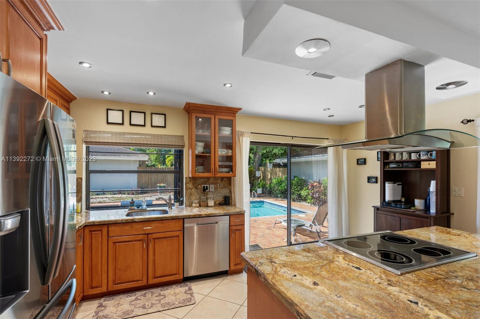 28 Cedar Road Hollywood, FL 33021 - Photo 5 of 43 a kitchen with stainless steel appliances granite countertop a refrigerator and a stove top oven