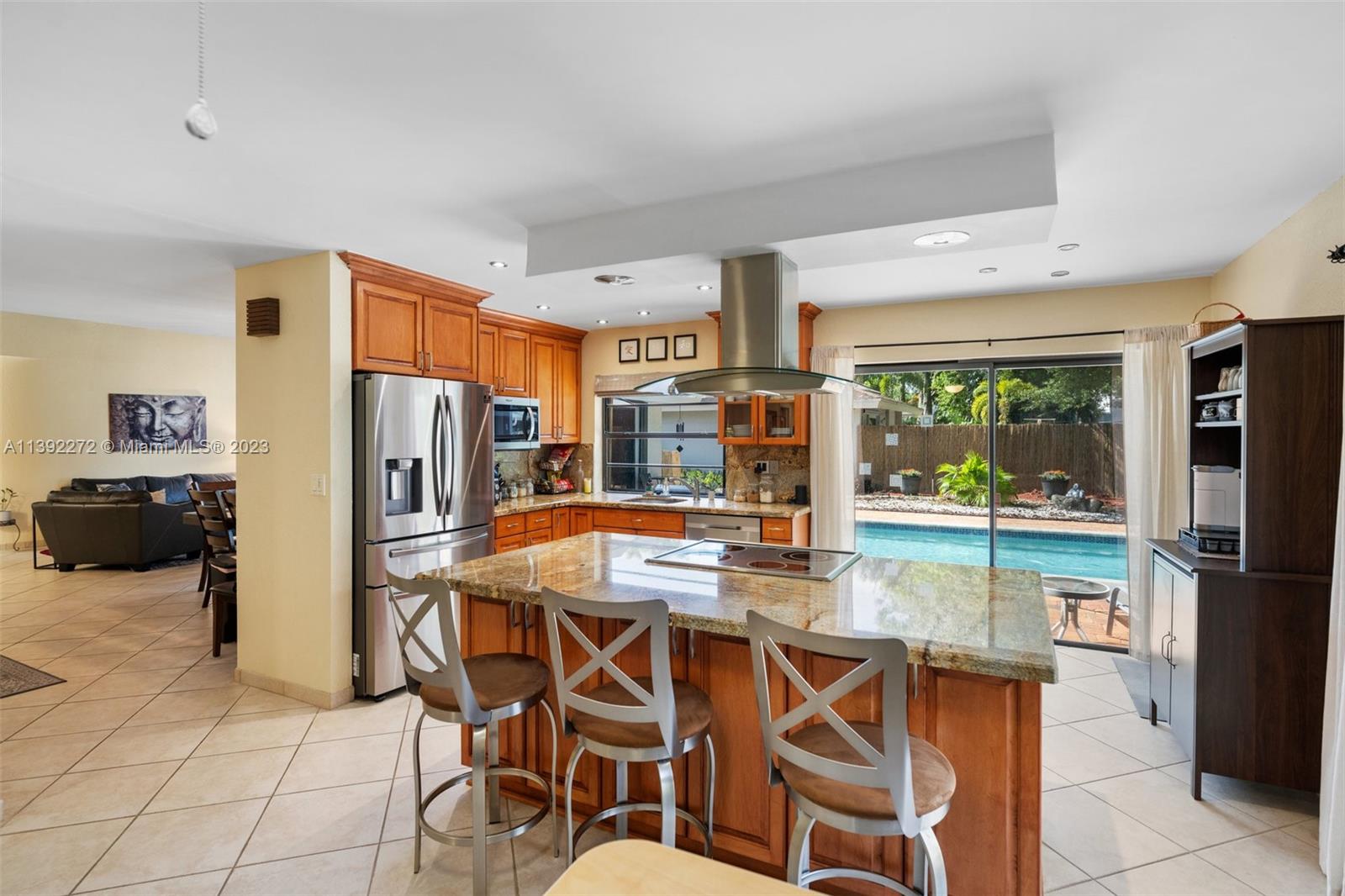 28 Cedar Road Hollywood, FL 33021 - Photo 8 of 43 a kitchen with stainless steel appliances a refrigerator a stove a sink dishwasher and white cabinets with wooden floor