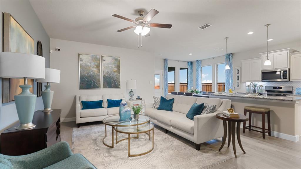 117 Hugo Court Rhome, TX 76078 - Photo 12 of 39 a living room with furniture kitchen view and a chandelier
