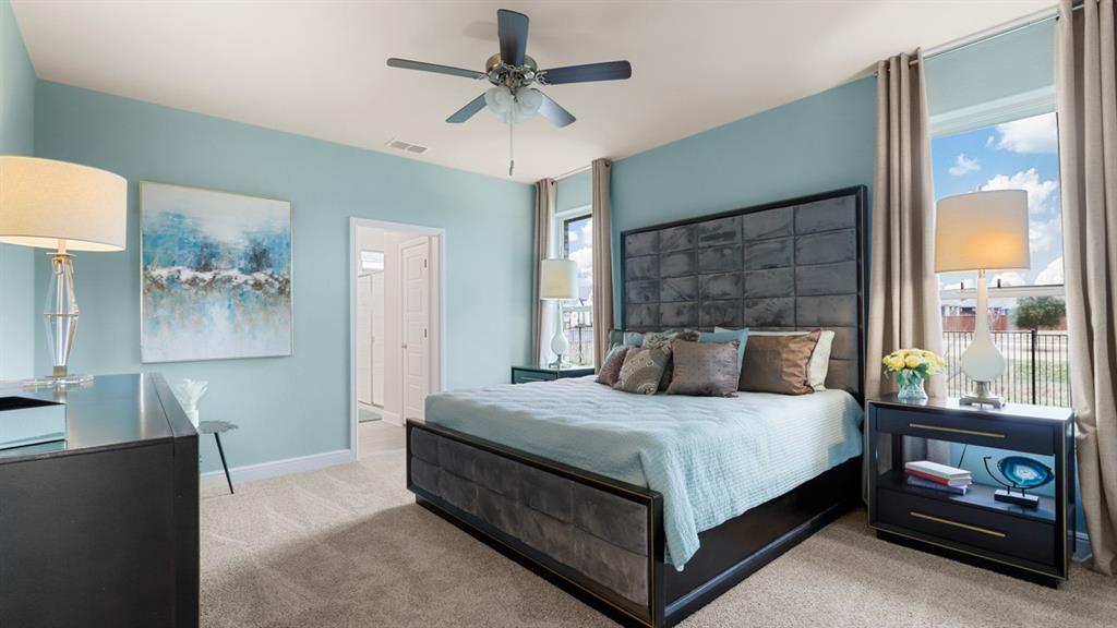 117 Hugo Court Rhome, TX 76078 - Photo 16 of 39 a bedroom with a bed and a chandelier