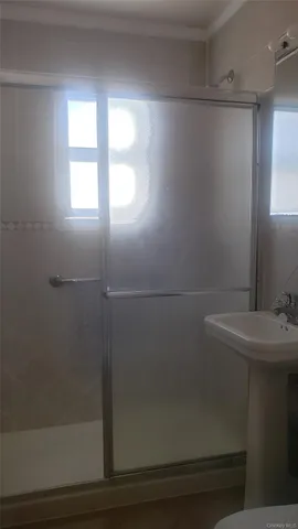 a bathroom with a sink a toilet and window