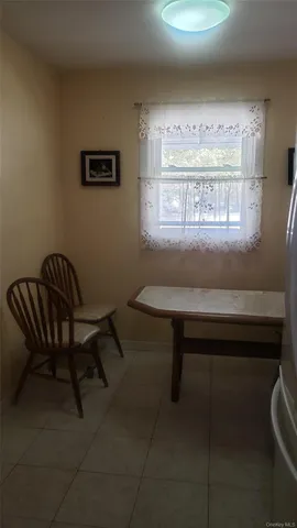 a workspace room with furniture and a window