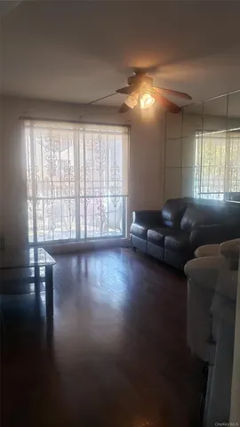 a living room with furniture window and wooden floor