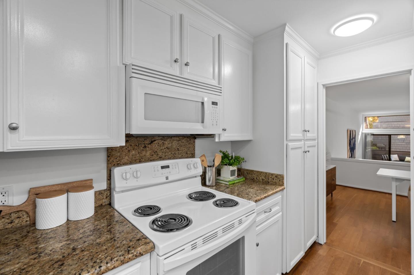 2146 Sand Hill Road Menlo Park, CA 94025 - Photo 12 of 40 a kitchen with a stove and white cabinets