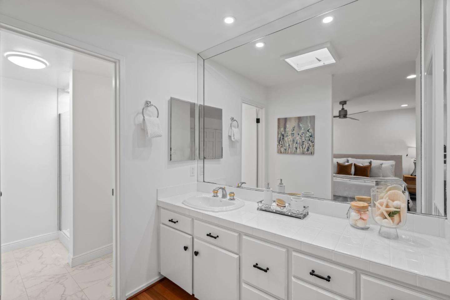 2146 Sand Hill Road Menlo Park, CA 94025 - Photo 23 of 40 a bathroom with double vanity sink a mirror and shower