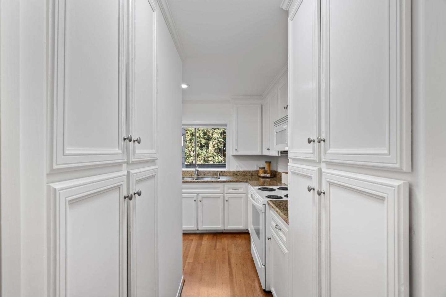 2146 Sand Hill Road Menlo Park, CA 94025 - Photo 9 of 40 a kitchen with white cabinets and white appliances