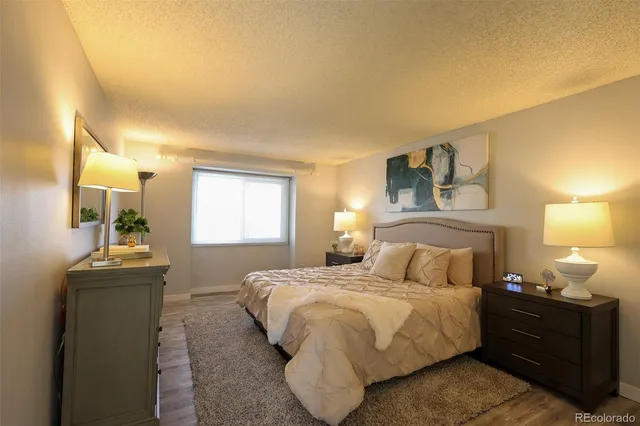 a bedroom with a bed and window with mirror