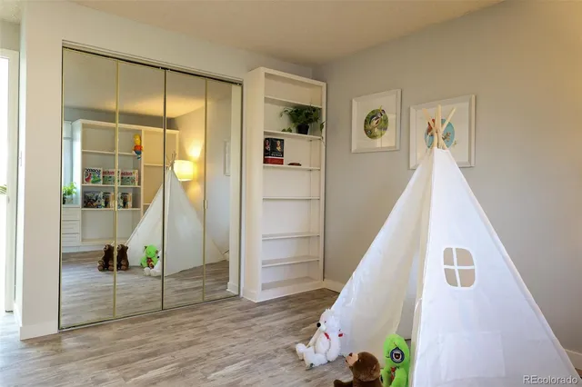 a view of hallway with stairs and wooden floor