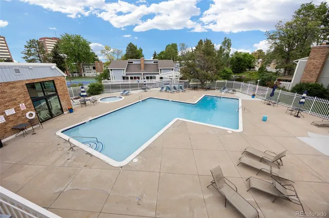 a view of a swimming pool with a patio and a fireplace