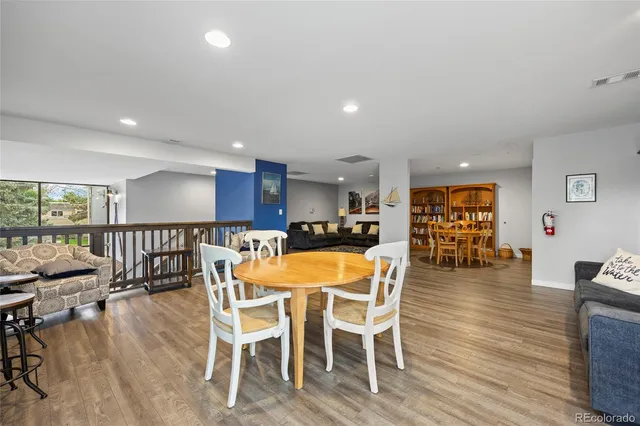 a dining room with furniture and wooden floor