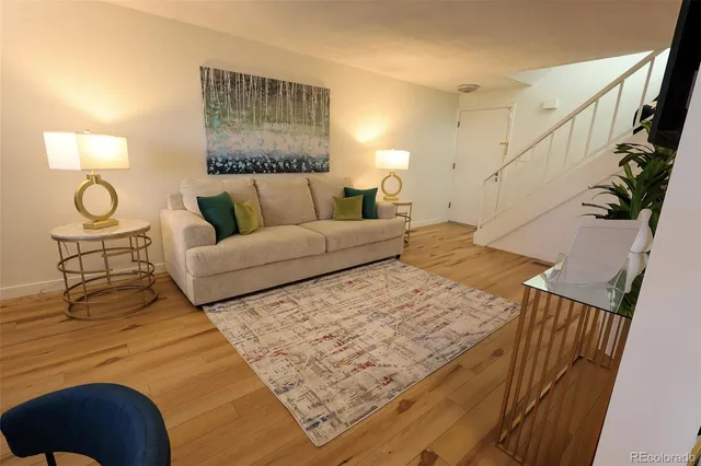 a living room with furniture and a lamp