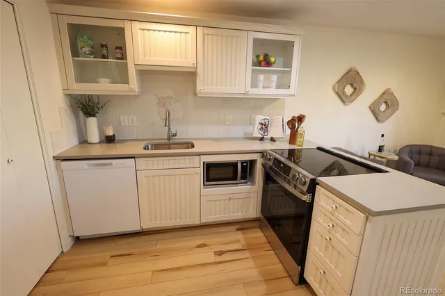 a kitchen with a sink stove and cabinets