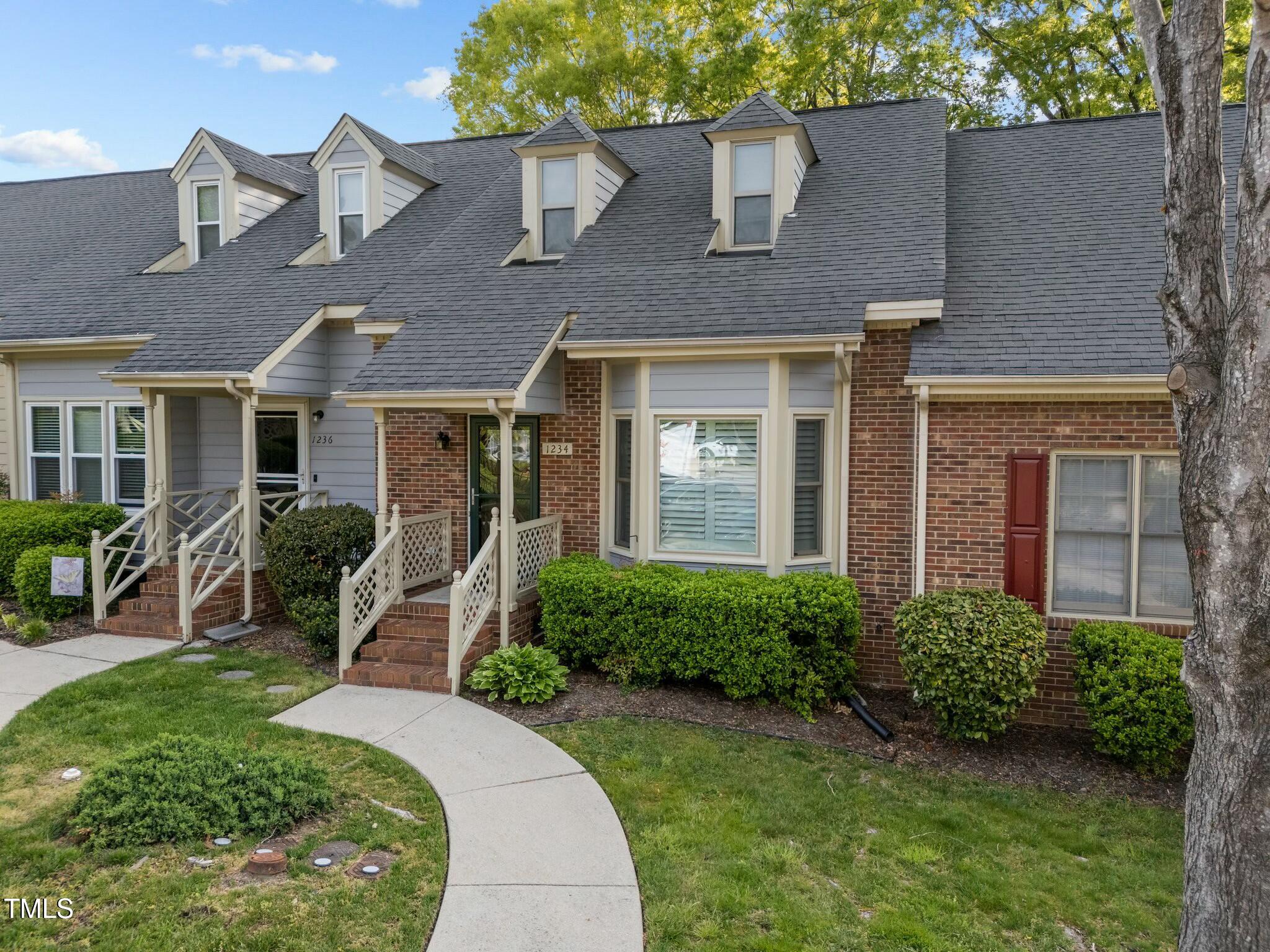 1234 Shadow Bark Court Raleigh, NC 27603 - Photo 1 of 36 a front view of a house with porch and glass windows