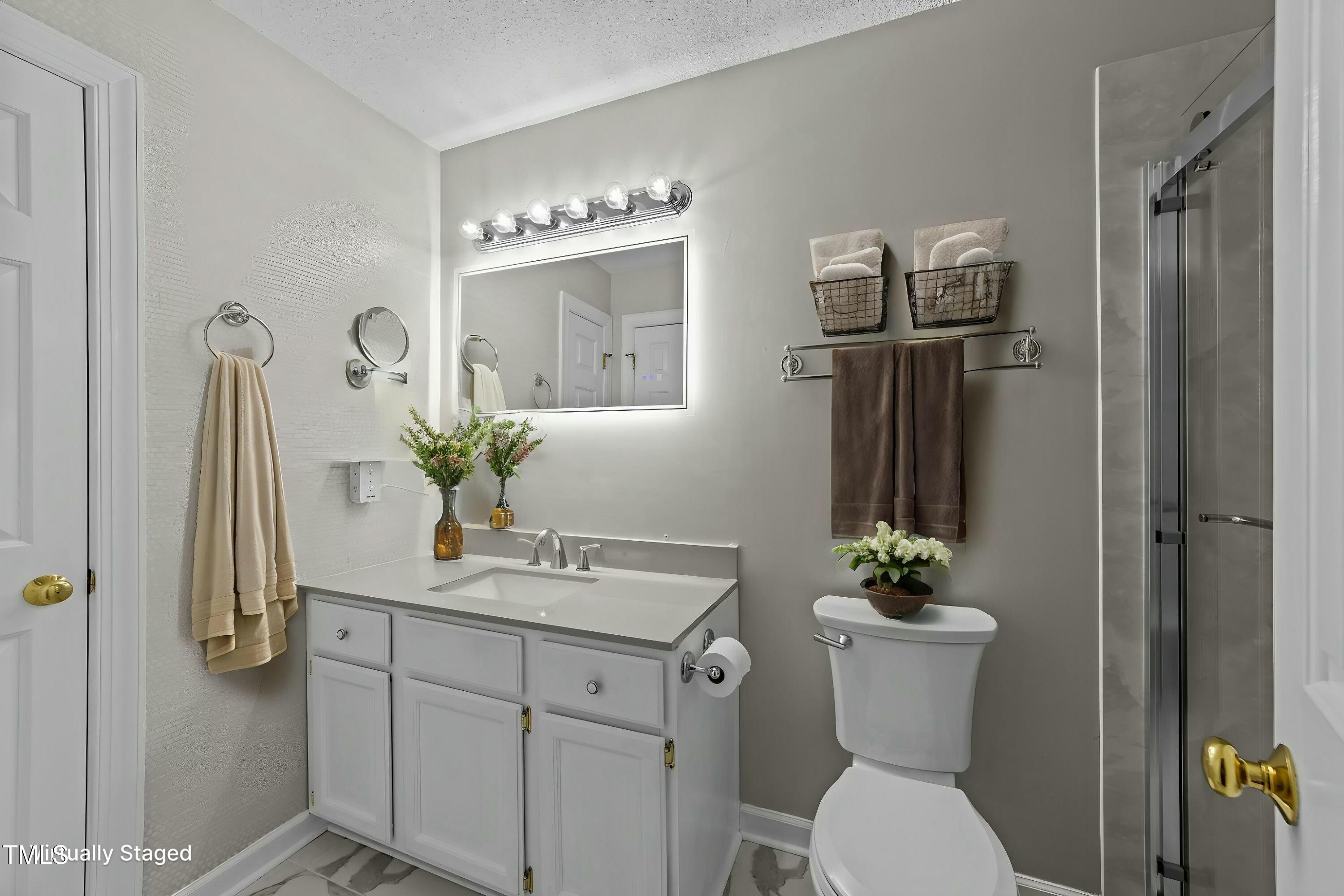 1234 Shadow Bark Court Raleigh, NC 27603 - Photo 25 of 36 a bathroom with a toilet sink and shower