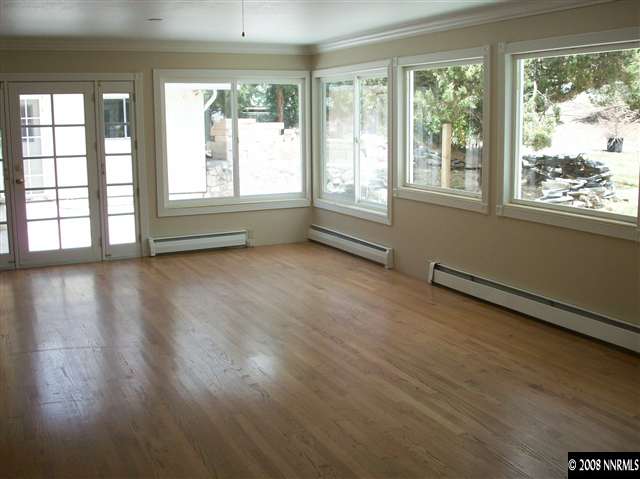 14440 Virginia Foothills Drive Reno, NV 89521 - Photo 7 of 9 a view of an empty room with wooden floor and a window