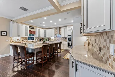 a kitchen with stainless steel appliances granite countertop a stove refrigerator and cabinets