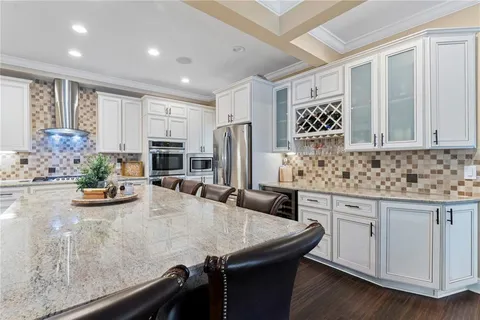 a kitchen with appliances a sink and cabinets