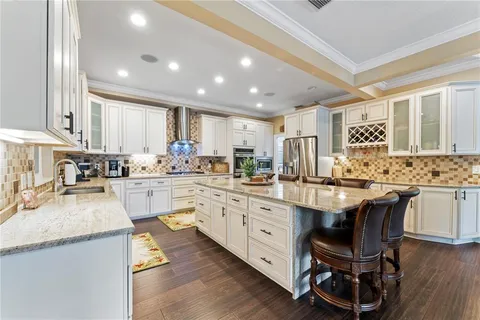a kitchen with granite countertop white cabinets and white appliances