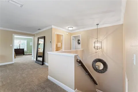 a living room with furniture gym equipment and a chandelier