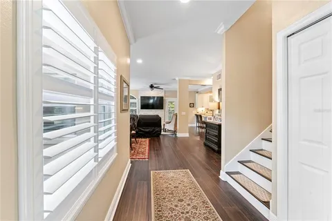 a view of entryway with wooden floor and stairs