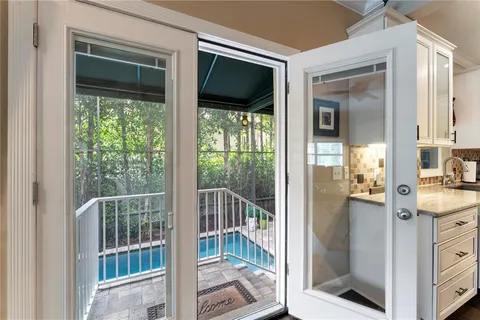 a view of a patio with chairs and a potted plant