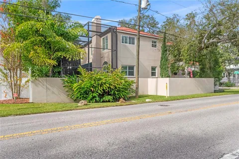 an aerial view of a house with swimming pool and garden