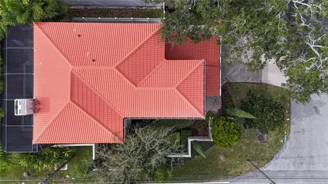 an aerial view of lake residential house with swimming pool and green space