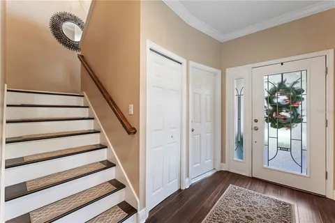 a view of living room kitchen with furniture and wooden floor