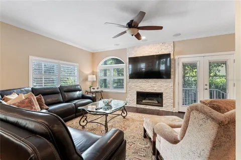 a living room with furniture wooden floor and a window