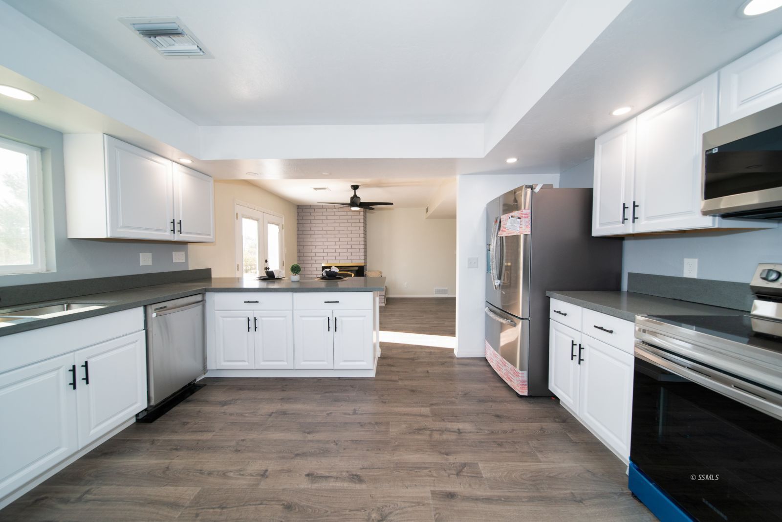 1965 South Downs Street Ridgecrest, CA 93555 - Photo 11 of 31 a large kitchen with cabinets wooden floor and stainless steel appliances
