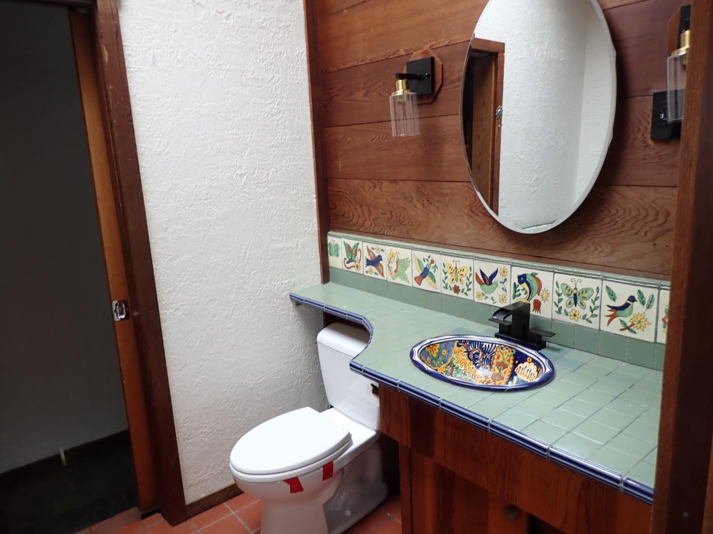 18039 Riverside Drive Sonoma, CA 95476 - Photo 16 of 21 a bathroom with a toilet a sink and a mirror