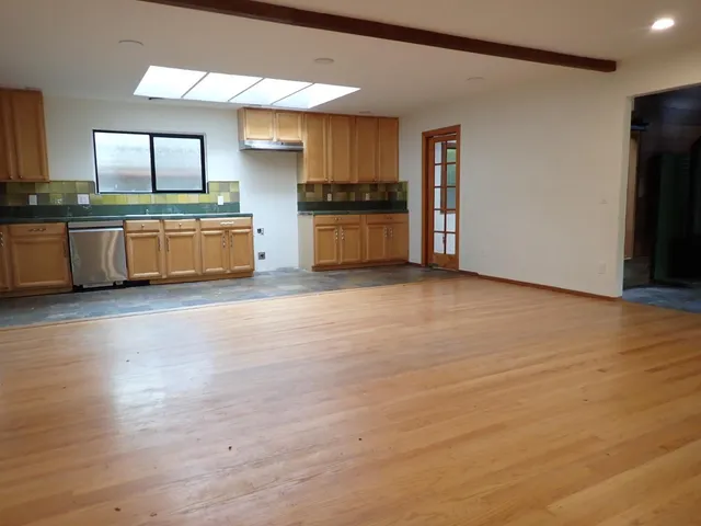 a kitchen with stainless steel appliances a refrigerator and a stove top oven