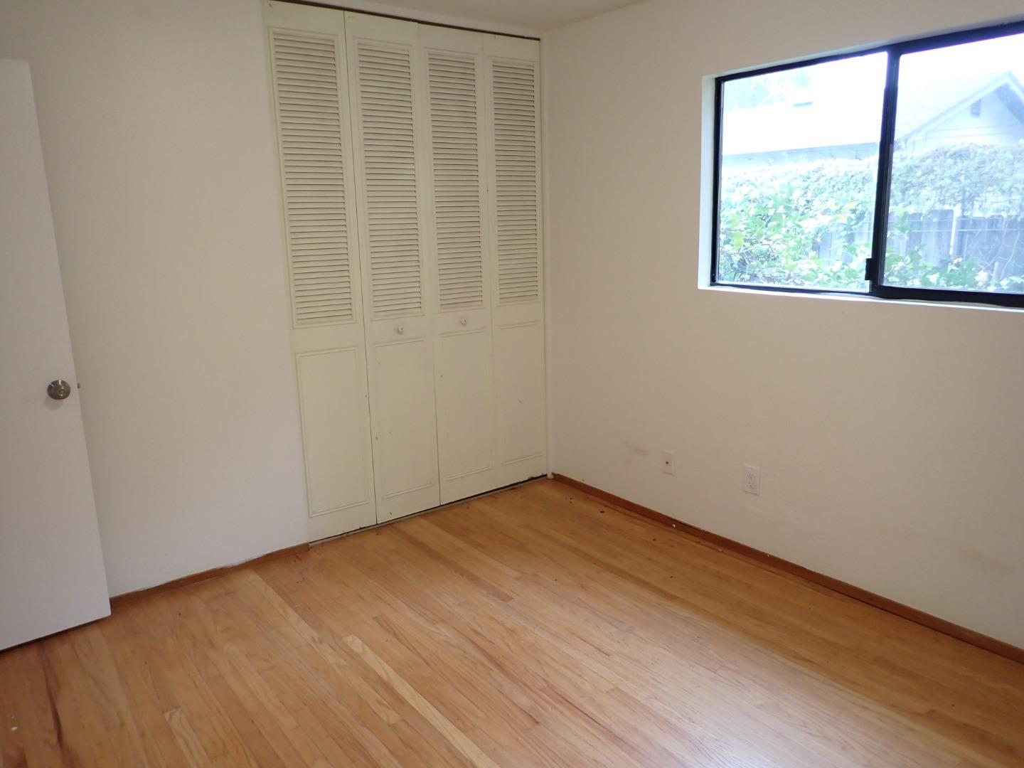 18039 Riverside Drive Sonoma, CA 95476 - Photo 8 of 21 an empty room with wooden floor and windows