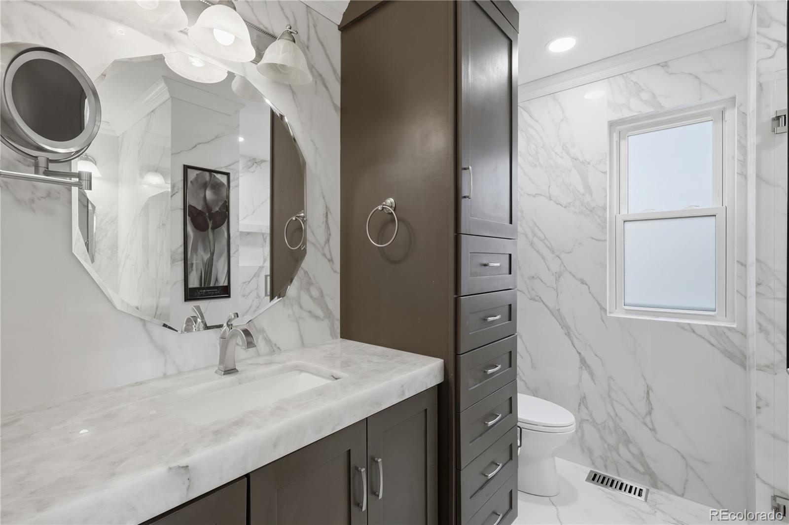 3807 Garnet Way Highlands Ranch, CO 80126 - Photo 22 of 38 a bathroom with a granite countertop sink mirror and toilet