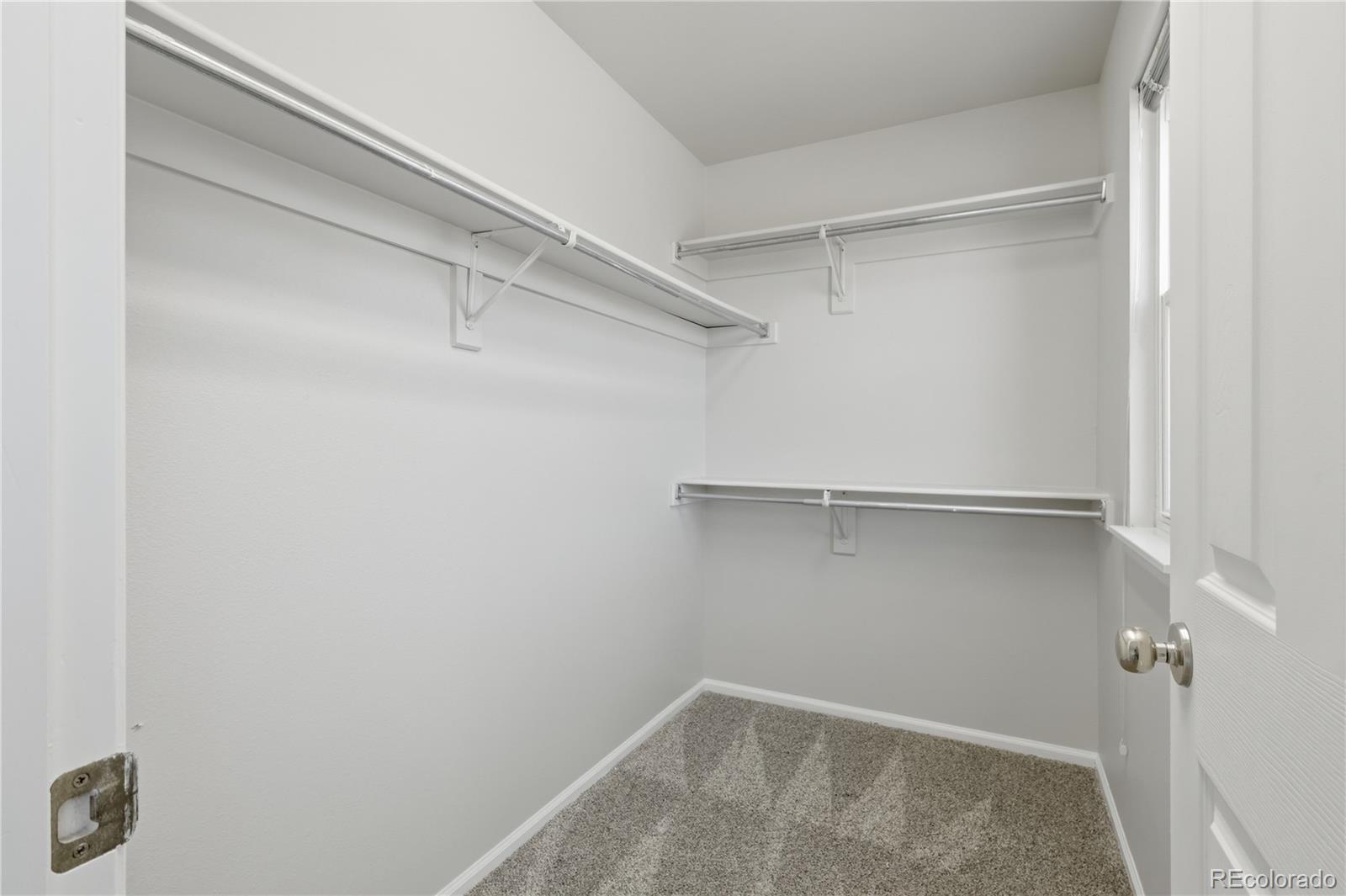 3807 Garnet Way Highlands Ranch, CO 80126 - Photo 25 of 38 a view of walk in closet with empty racks