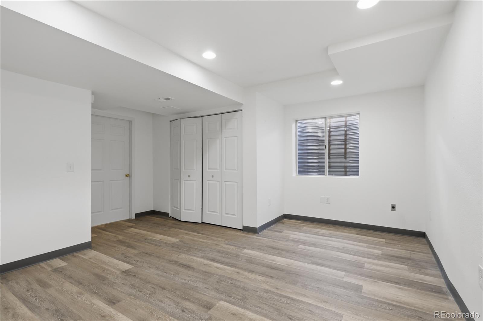 3807 Garnet Way Highlands Ranch, CO 80126 - Photo 31 of 38 a view of an empty room with wooden floor and a window