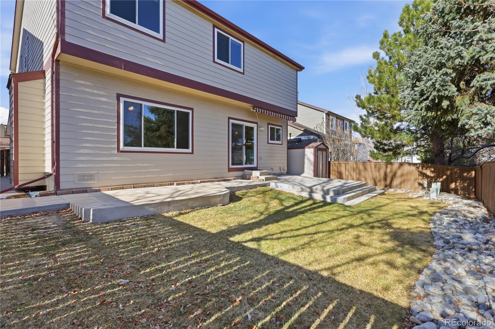3807 Garnet Way Highlands Ranch, CO 80126 - Photo 32 of 38 a view of a house with a swimming pool