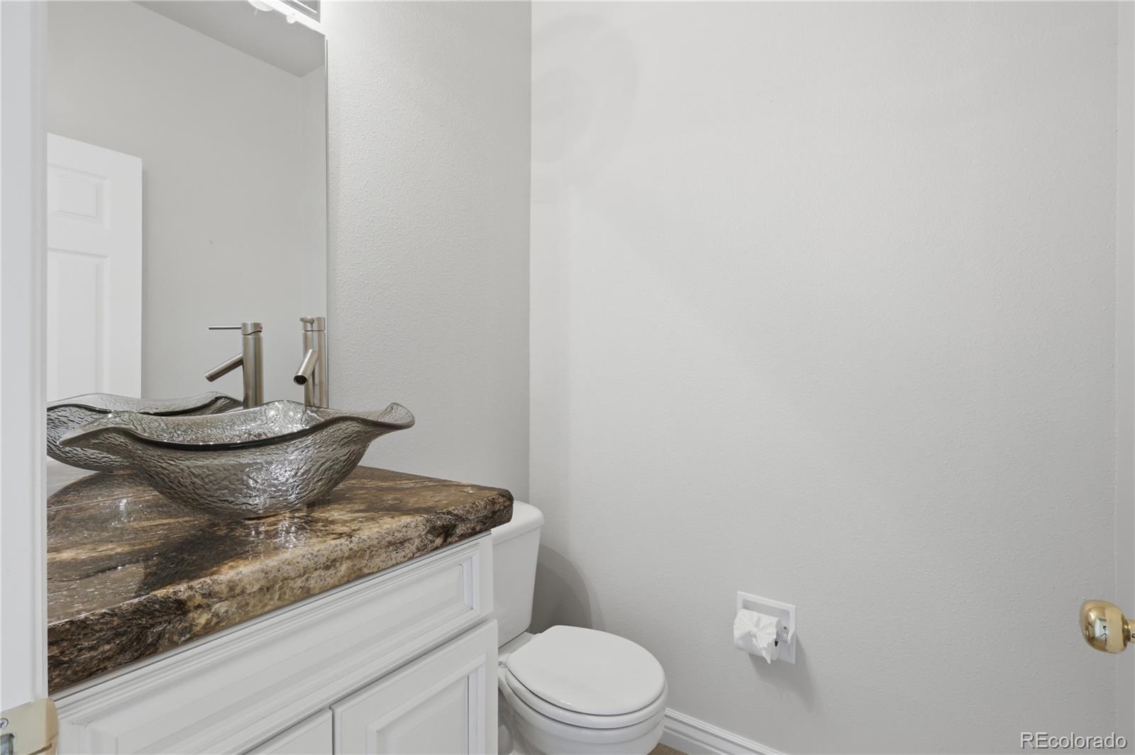 3807 Garnet Way Highlands Ranch, CO 80126 - Photo 6 of 38 a view of a bathroom with a sink and a toilet