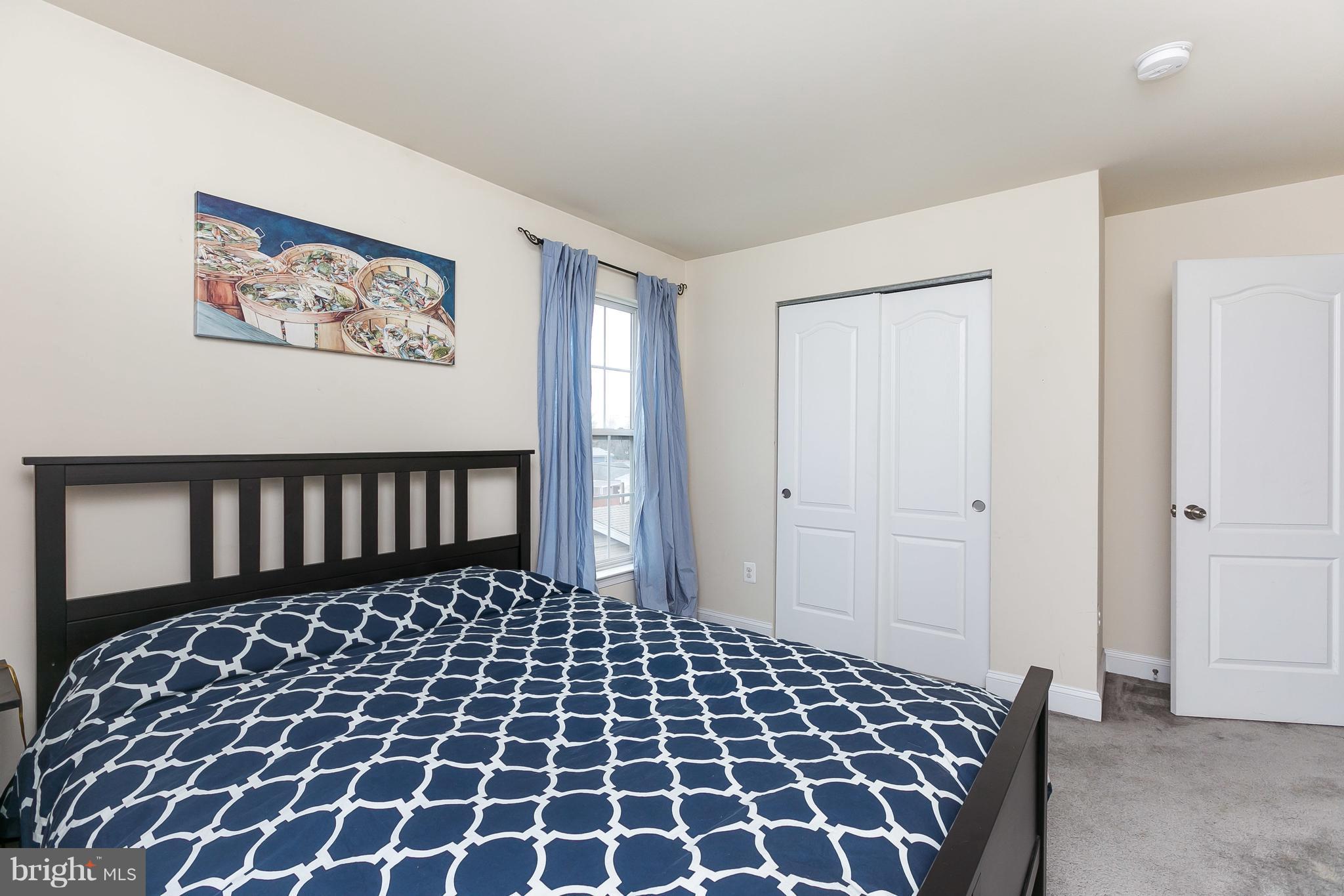 1305 3rd Road Baltimore, MD 21220 - Photo 13 of 27 a large bedroom with a black and white checkered floor